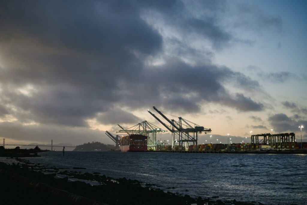 Container port with ship-to-shore cranes at dusk
