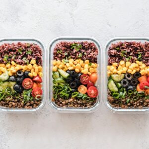 Glass food storage containers filled with grains and vegetables