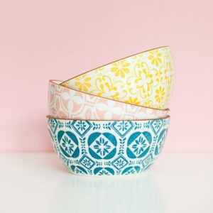 Stack of hand-painted ceramic bowls with floral patterns