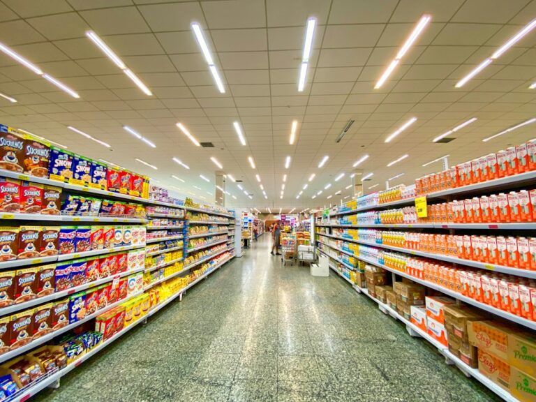 Grocery store aisle with fully stocked shelves