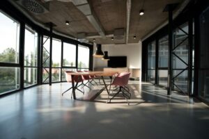 Modern open office meeting space with tall windows