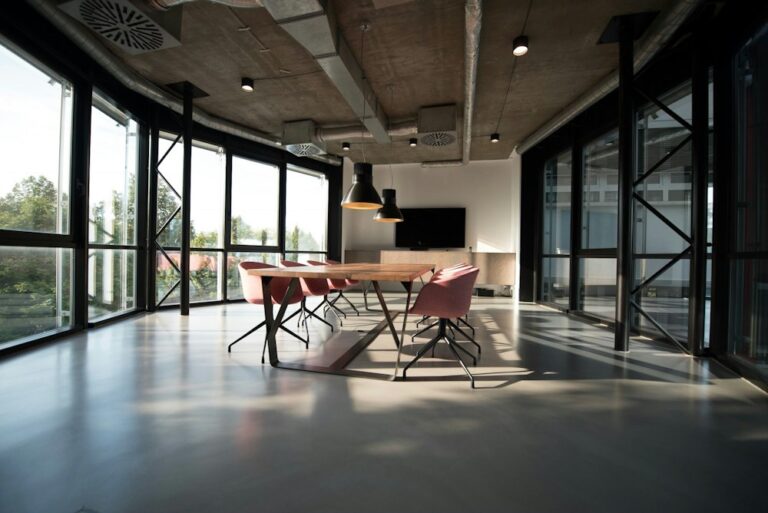 Modern open office meeting space with tall windows