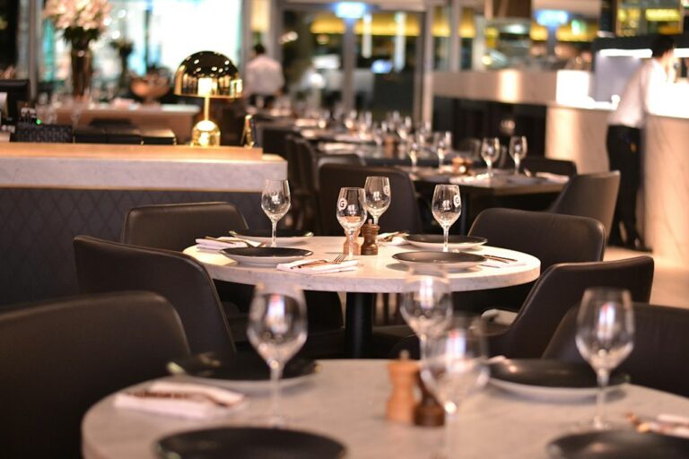 Restaurant dining room with tables set with glassware