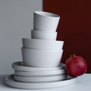 Stack of white stoneware bowls and plates