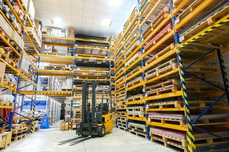 Warehouse aisle with pallet racking and a forklift